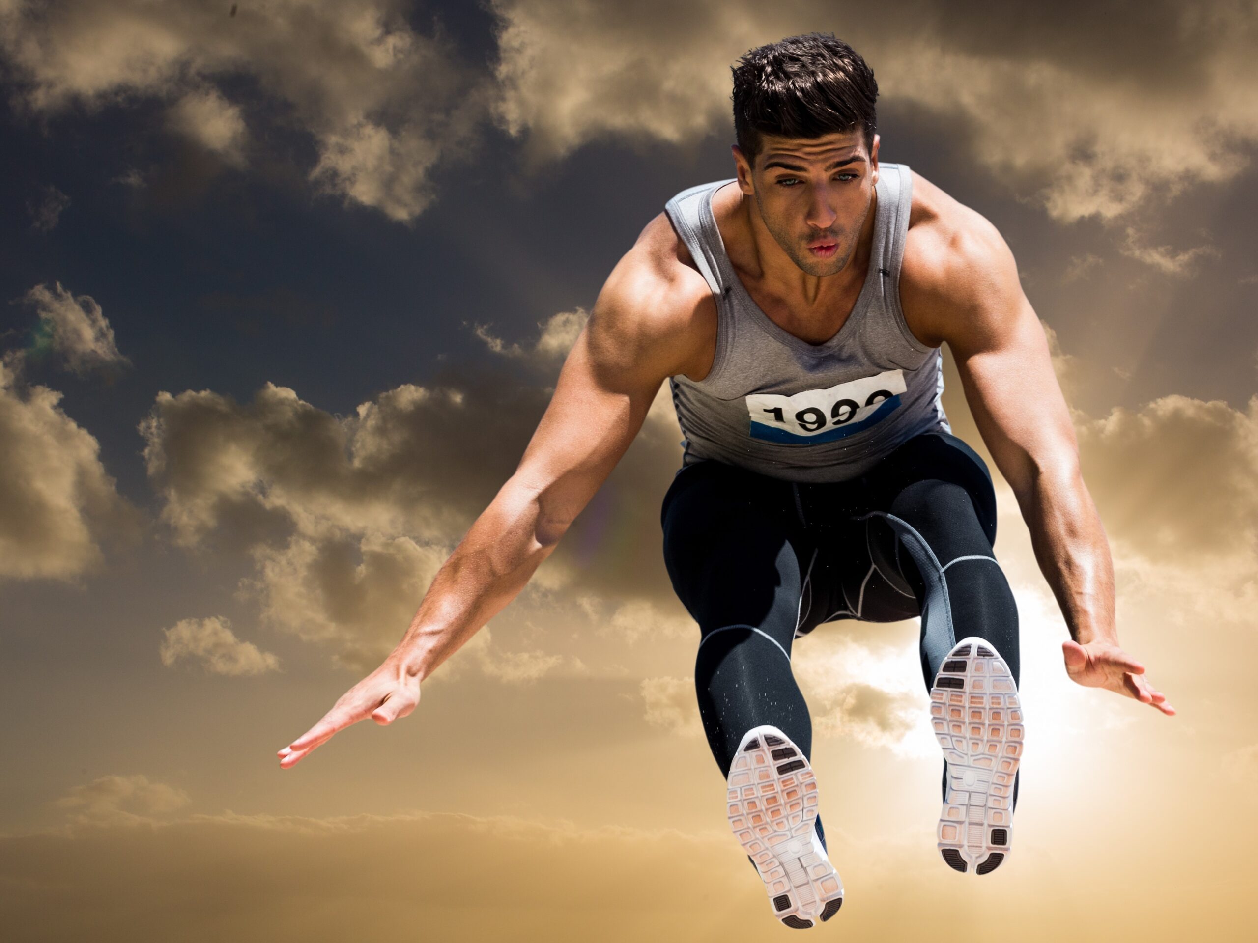 Athlete practicing high jump against sky in background